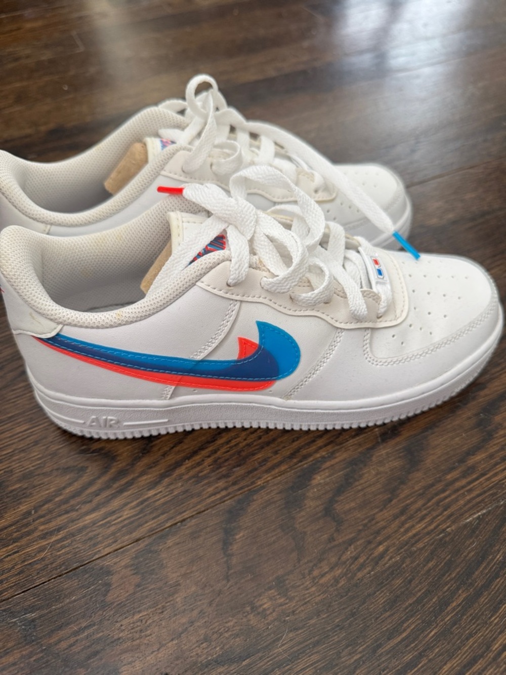 Nike Kids White Sneakers with Blue & Red Swoosh